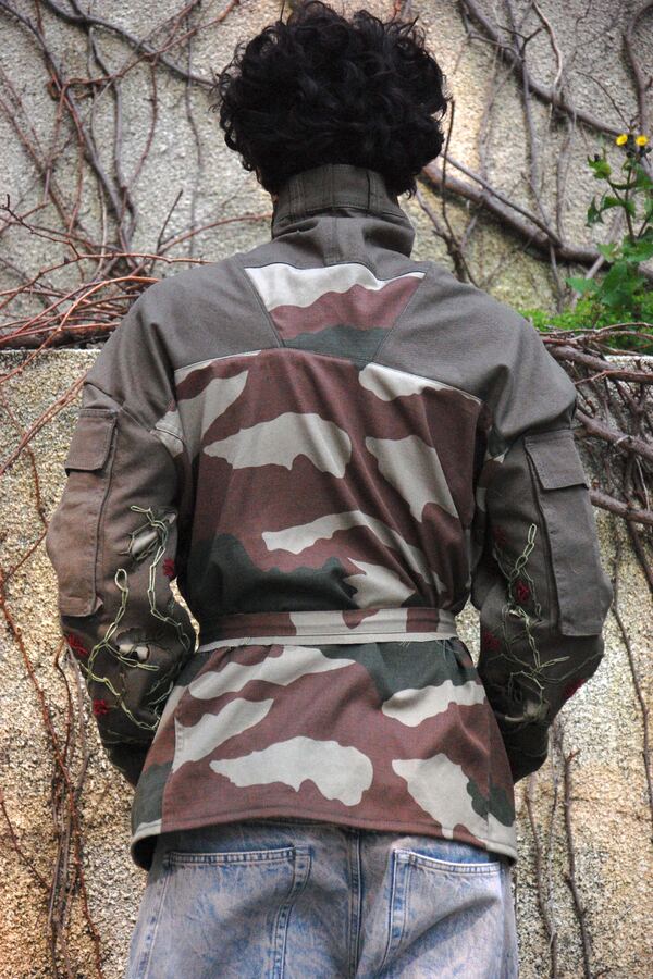 The same jacket from behind: the sash tied at the waist and the camouflage back panelled from several garments.