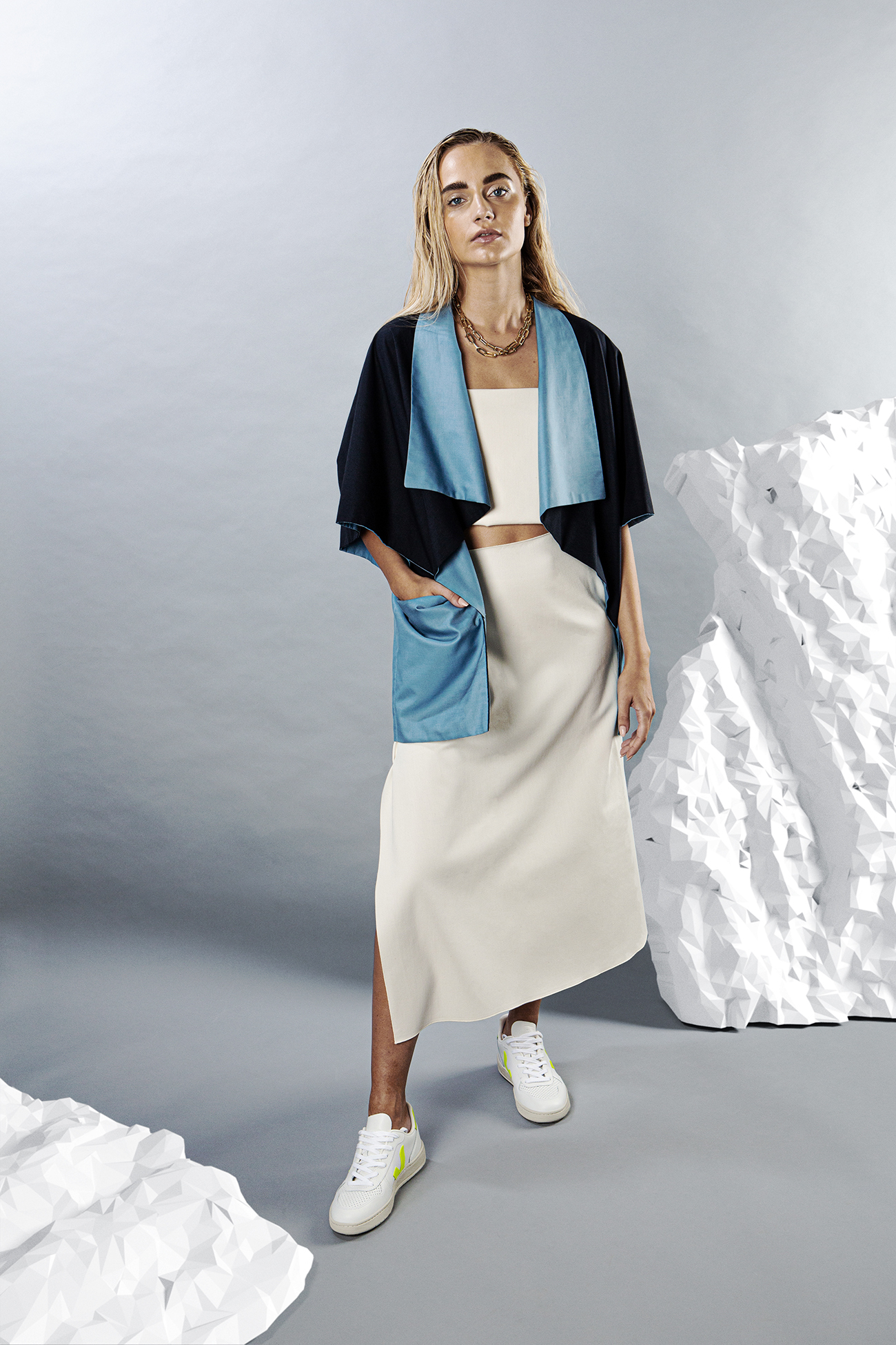 A modular Refashion look with a reversible navy and blue jacket over a cream skirt.